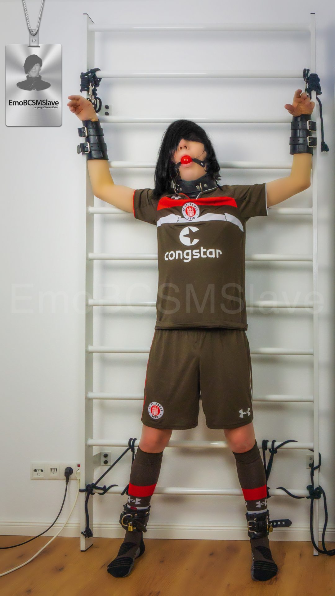 Soccer EmoBCSMSlave tied to wall bars and vacuum mask breath controlled