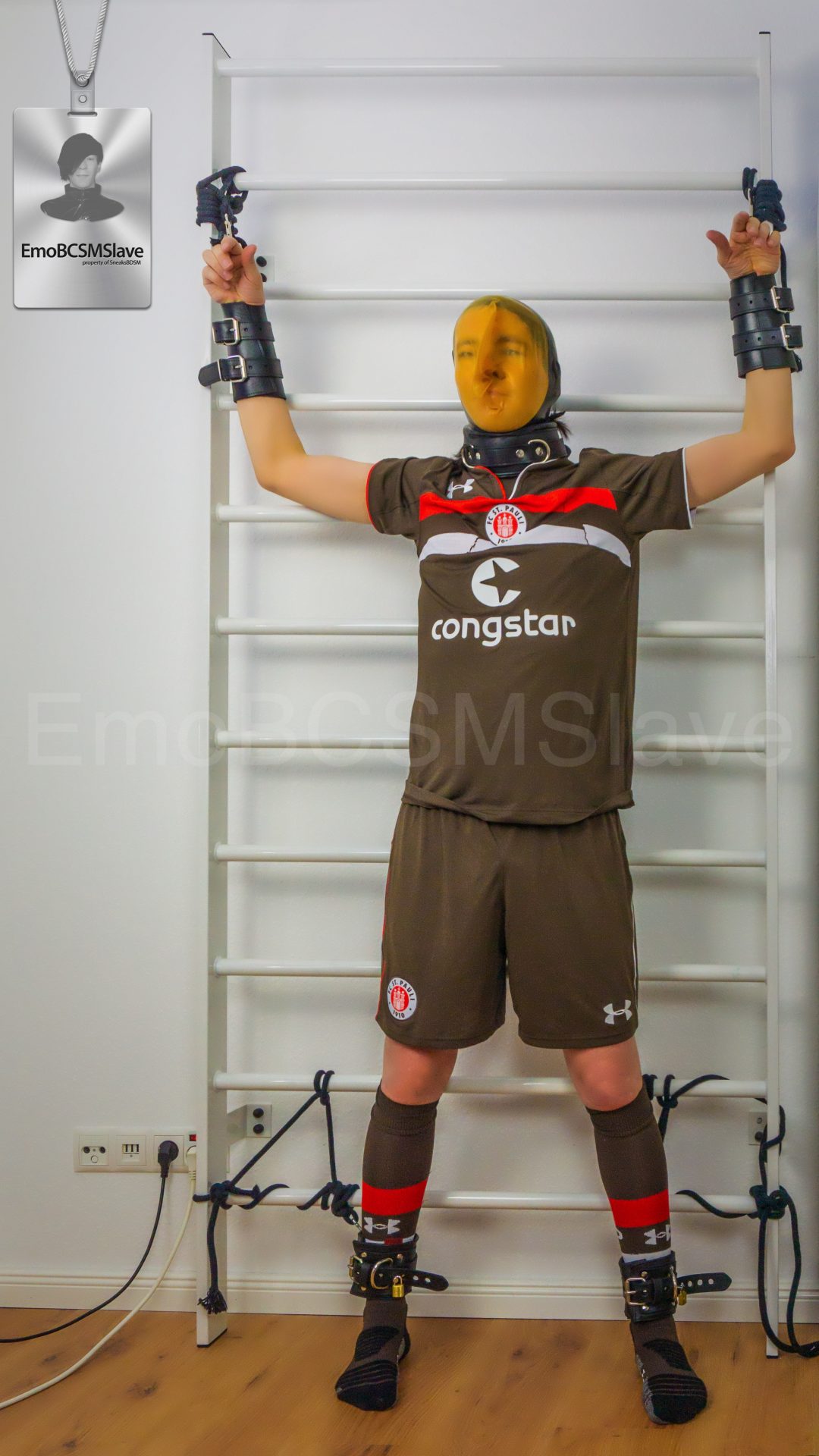 Soccer EmoBCSMSlave tied to wall bars and vacuum mask breath controlled