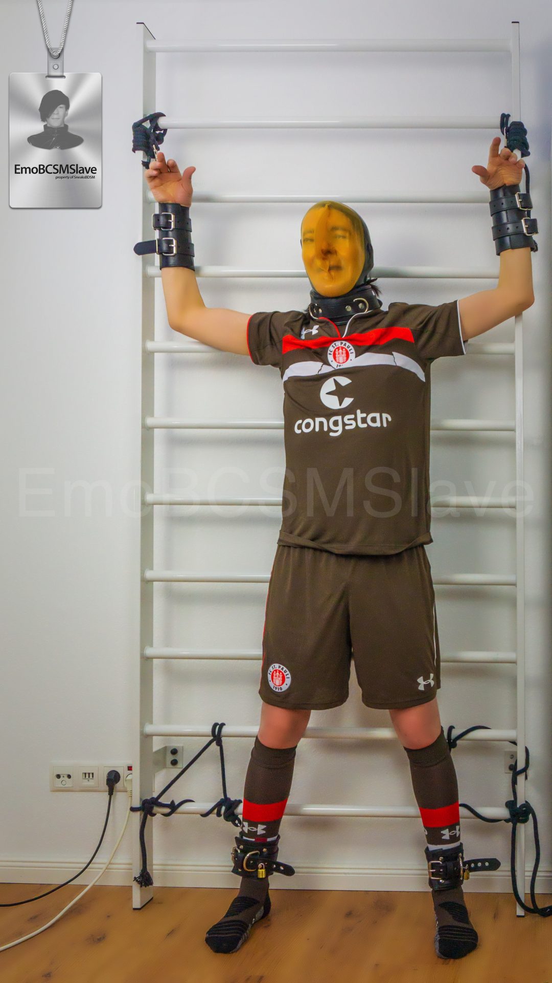 Soccer EmoBCSMSlave tied to wall bars and vacuum mask breath controlled