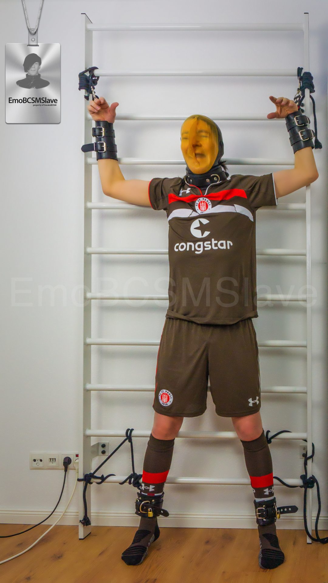 Soccer EmoBCSMSlave tied to wall bars and vacuum mask breath controlled